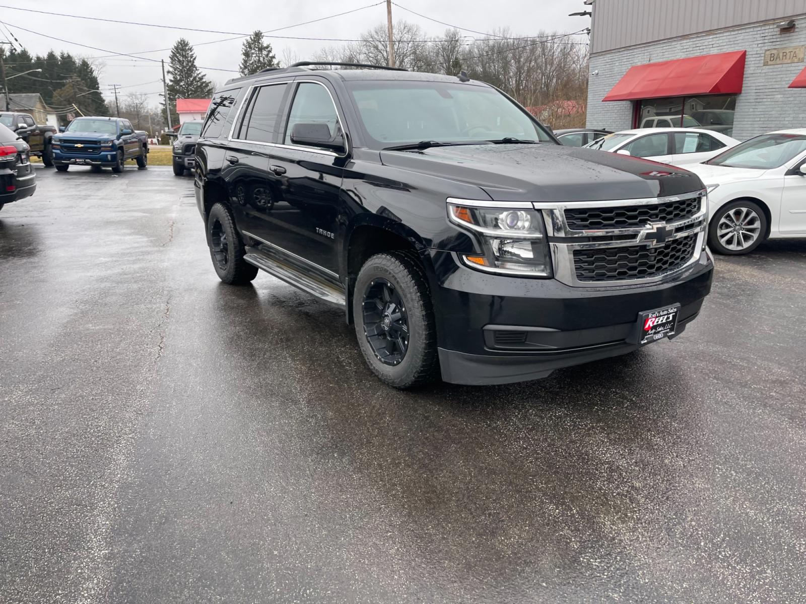 2015 Black /Black Chevrolet Tahoe LS 4WD (1GNSKAEC8FR) with an 5.3L V8 OHV 16V engine, 6-Speed Automatic transmission, located at 547 E. Main St., Orwell, OH, 44076, (440) 437-5893, 41.535435, -80.847855 - This 2015 Chevrolet Tahoe LS 4WD is a versatile and robust full-size SUV that offers a range of comfort and utility features, appealing to families and those needing a capable vehicle for towing and outdoor adventures. Equipped with Tri-Zone Automatic Climate Control, Power Front Seats, and Rain Sen - Photo #2